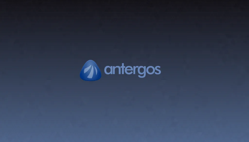 The Antergos logo — a blue rounded triangle with a white sail inside it — next to the antergos wordmark, on a dark blue wallpaper.